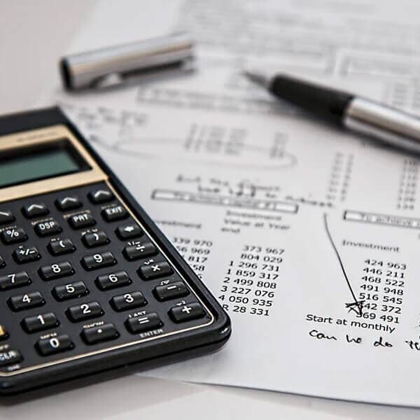 Accountant reviewing figures with a calculator